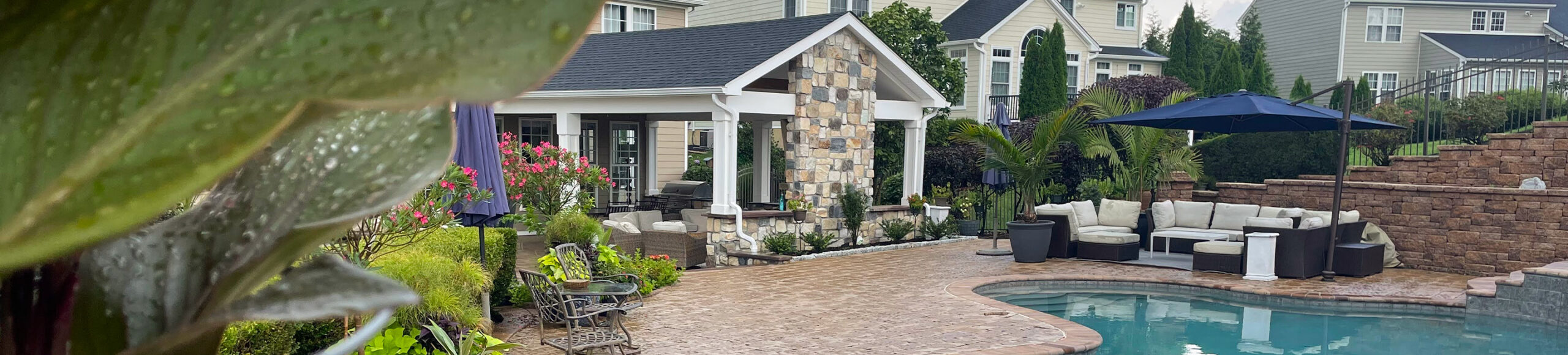 backyard with pool and two seating areas from CKC Landscaping