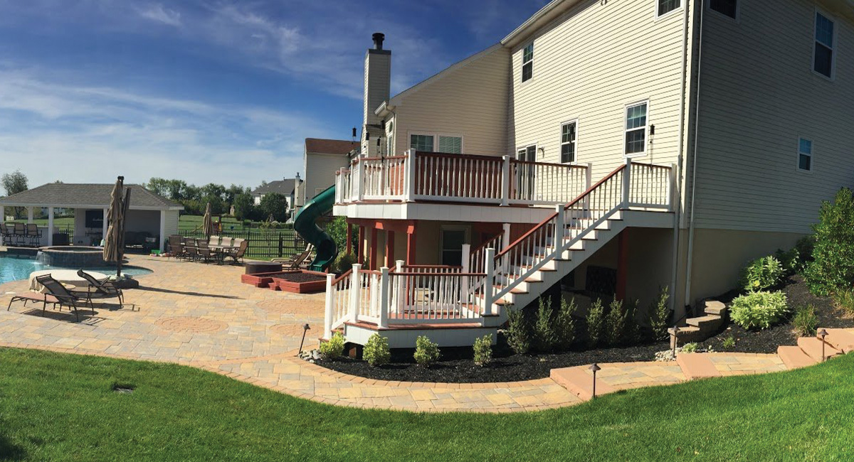 large backyard with deck and patio with pool from CKC Landscaping