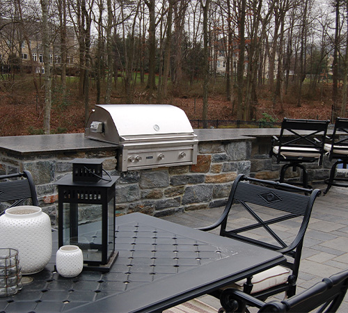 patio with built in grill and bar seating from CKC Landscaping